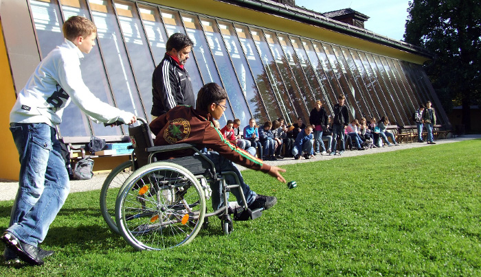 A disabled person playing Boccia