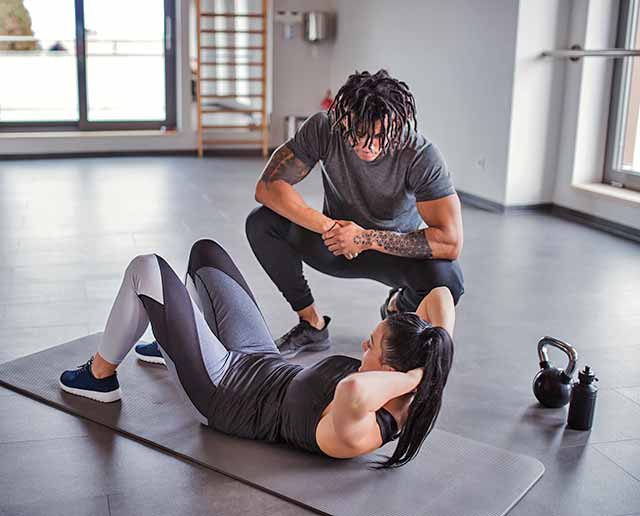 Personal trainer helping a client